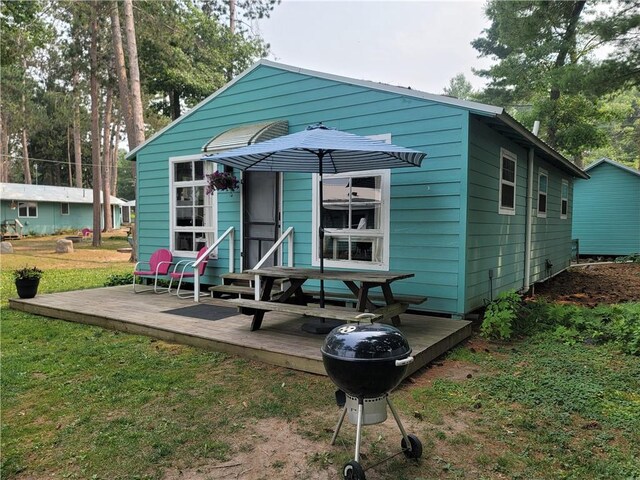 rear view of property featuring a deck