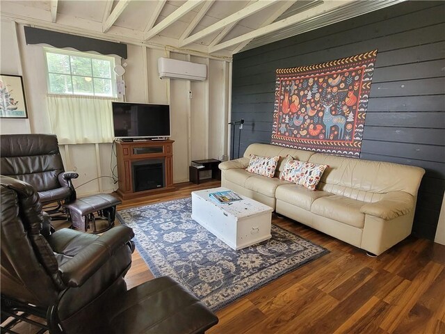 living room with lofted ceiling with beams, hardwood / wood-style flooring, a wall mounted AC, and wooden walls