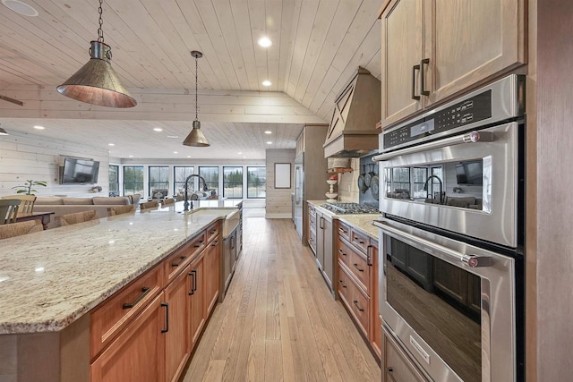 kitchen with pendant lighting, wooden ceiling, premium range hood, a large island with sink, and stainless steel appliances