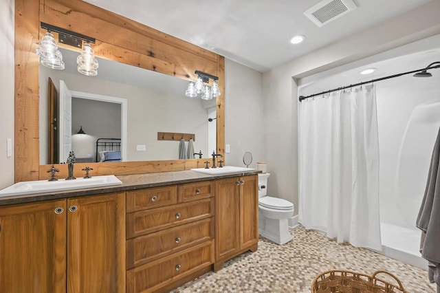 bathroom featuring curtained shower, vanity, and toilet