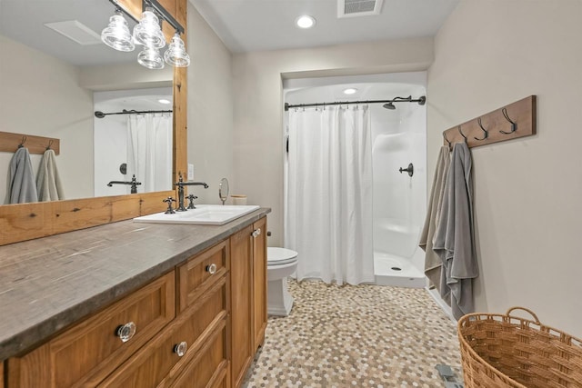 bathroom with vanity, toilet, and curtained shower