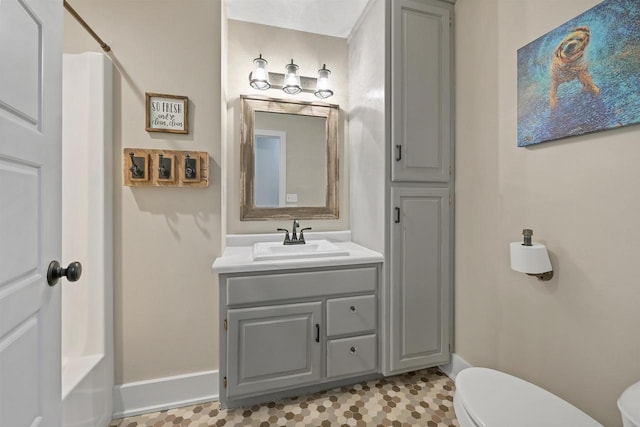 bathroom with tile patterned flooring, vanity, and toilet