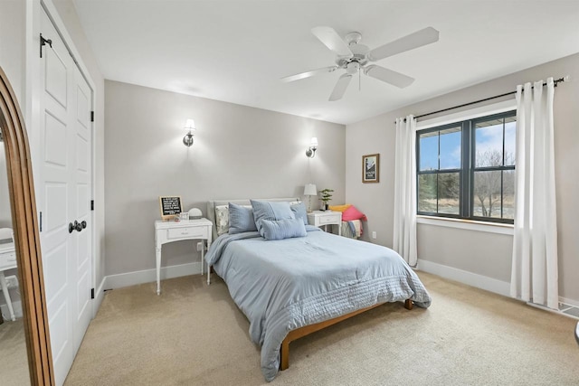 bedroom featuring ceiling fan and light carpet