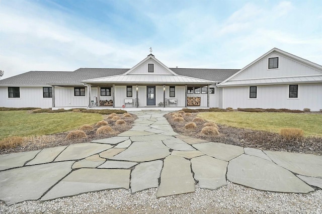 view of front of house with a porch and a front lawn