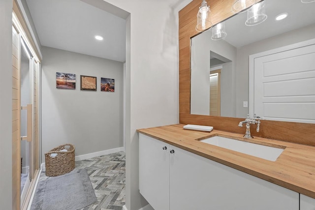 bathroom with vanity and parquet flooring