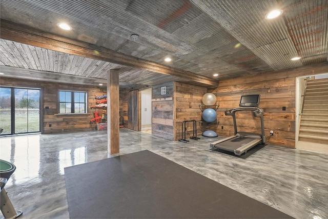 exercise room with wood ceiling and wood walls