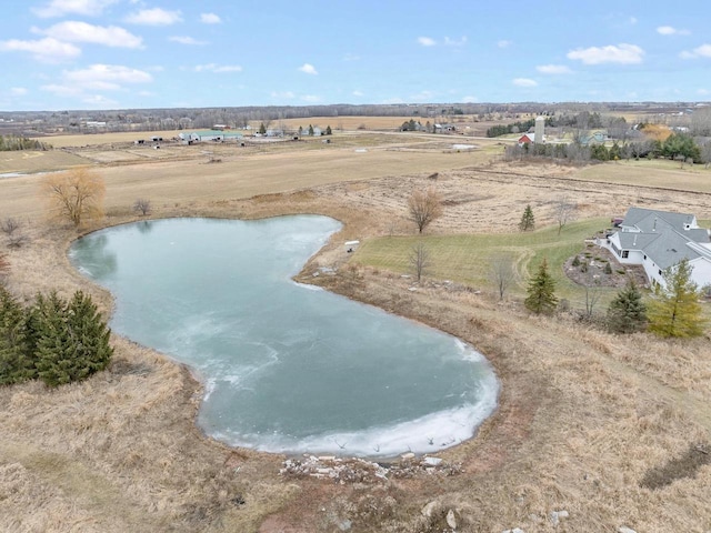 drone / aerial view featuring a water view and a rural view