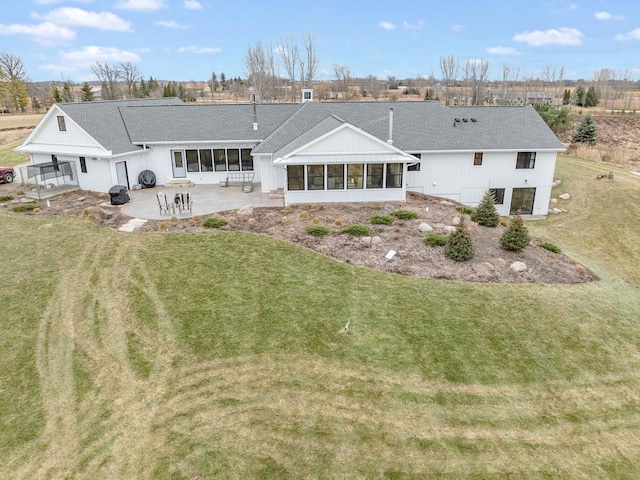 back of house with a lawn, a patio area, and a sunroom