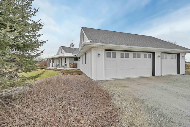 view of property exterior with covered porch and a garage