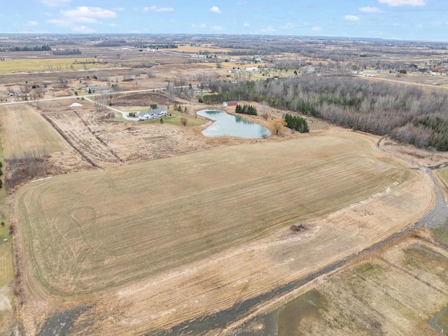 drone / aerial view featuring a rural view and a water view