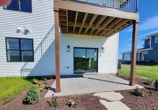 exterior space featuring central AC unit, a patio area, and a balcony