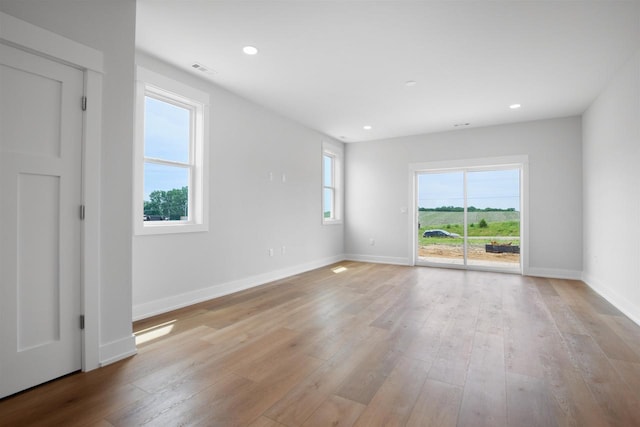 empty room with light hardwood / wood-style floors