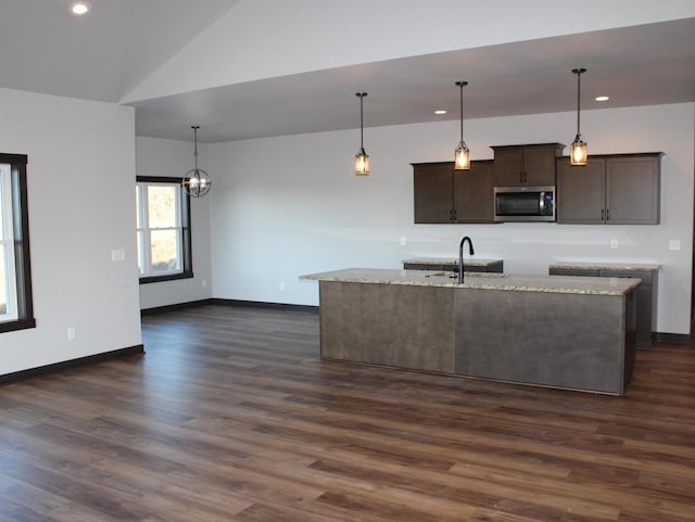 W4241 Hilltop Dr, Fond Du Lac, WI 54937 - kitchen with dark brown cabinets, an island with sink, decorative light fixtures, and sink