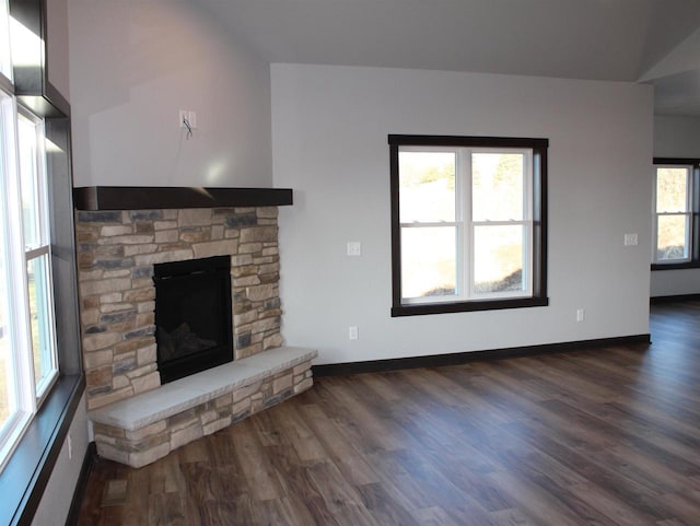 W4241 Hilltop Dr, Fond Du Lac, WI 54937 - unfurnished living room with lofted ceiling, a stone fireplace, and dark wood-type flooring