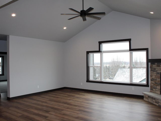 unfurnished living room featuring high vaulted ceiling, a stone fireplace, ceiling fan, and dark wood-type flooring