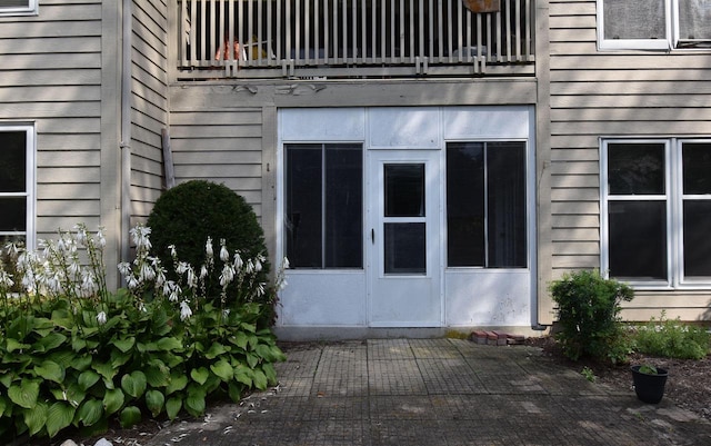 view of property exterior with a balcony and a patio area