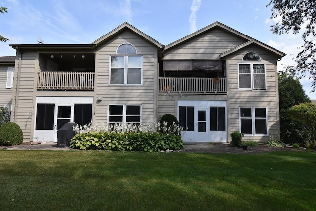 rear view of property with a yard