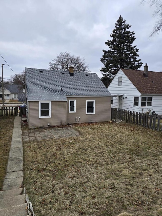 back of house featuring a yard