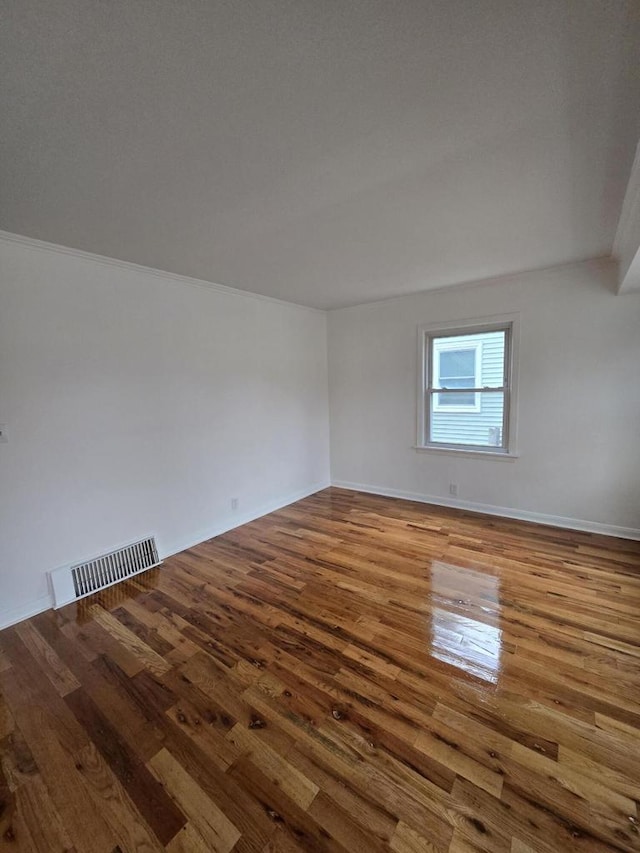 unfurnished room with crown molding and light hardwood / wood-style flooring