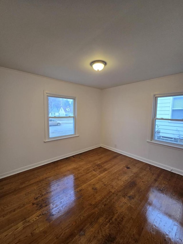 unfurnished room featuring dark hardwood / wood-style floors and plenty of natural light