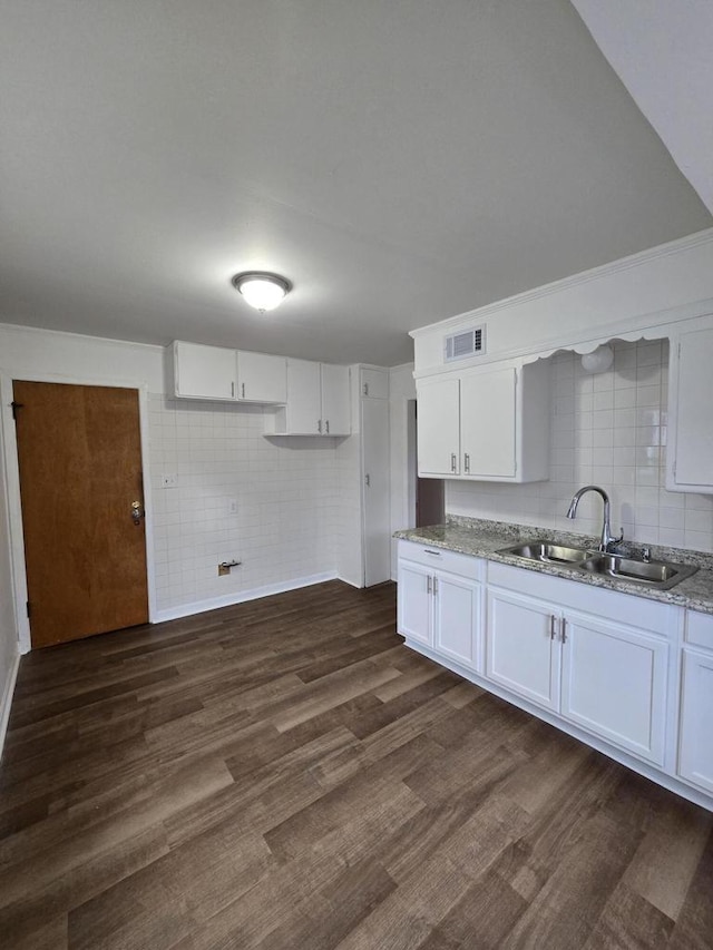 kitchen with white cabinetry, sink, and dark wood-type flooring