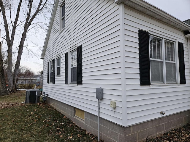 view of side of home featuring central AC