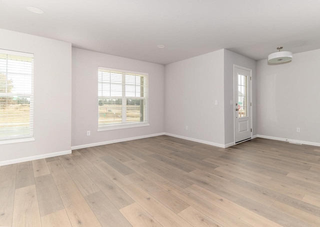 unfurnished room with light hardwood / wood-style floors