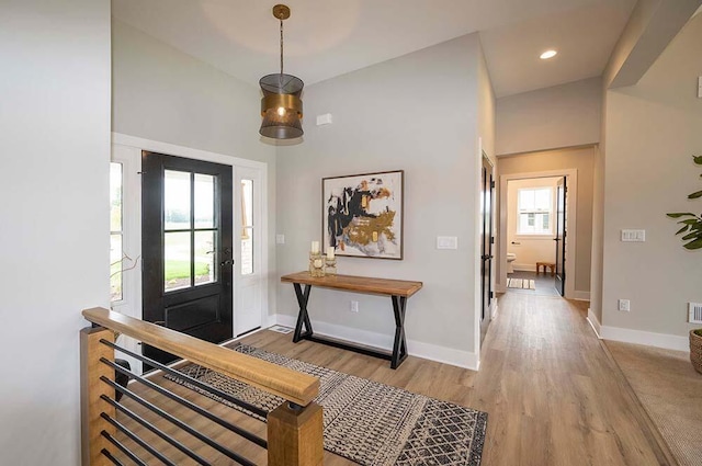 foyer featuring light hardwood / wood-style flooring and a high ceiling