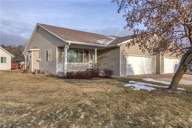 ranch-style house featuring central air condition unit, covered porch, a front yard, and a garage