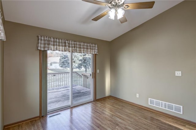 spare room featuring hardwood / wood-style floors and ceiling fan