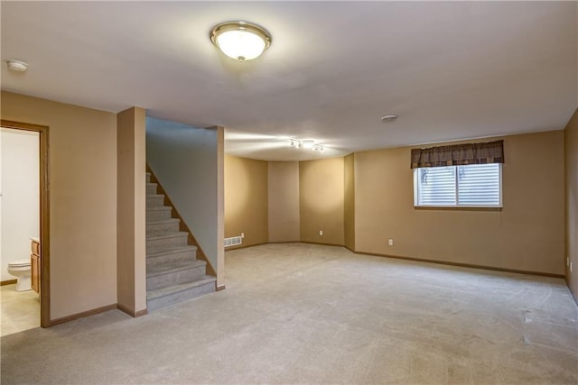 basement featuring light colored carpet