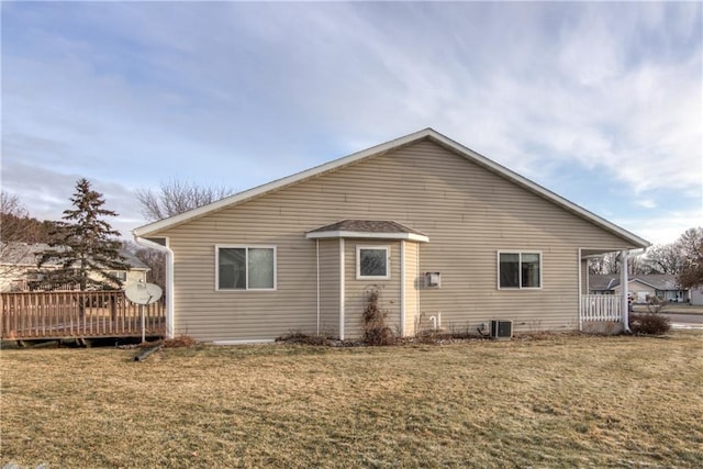 back of house with a lawn, cooling unit, and a deck