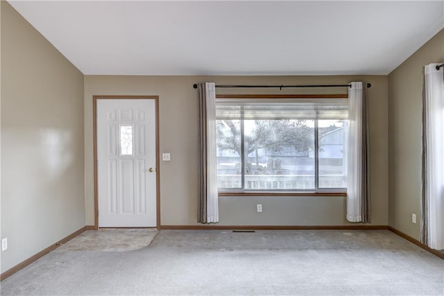 foyer featuring light colored carpet