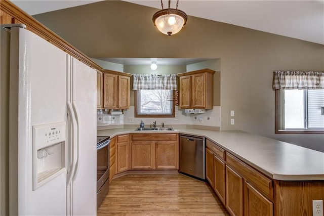 kitchen with kitchen peninsula, sink, a healthy amount of sunlight, and appliances with stainless steel finishes