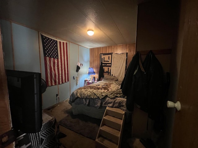 bedroom featuring wood walls