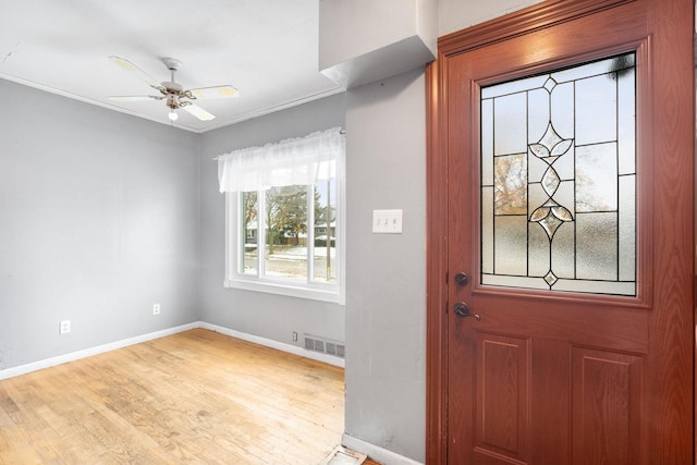 foyer with ceiling fan, crown molding, and light hardwood / wood-style floors