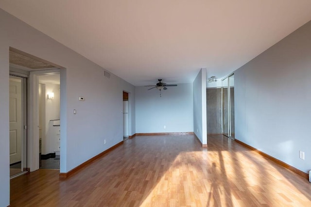 unfurnished living room featuring wood-type flooring and ceiling fan