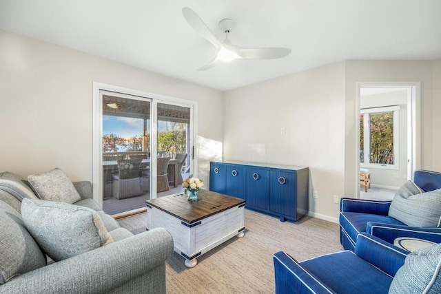 living room featuring light carpet and ceiling fan