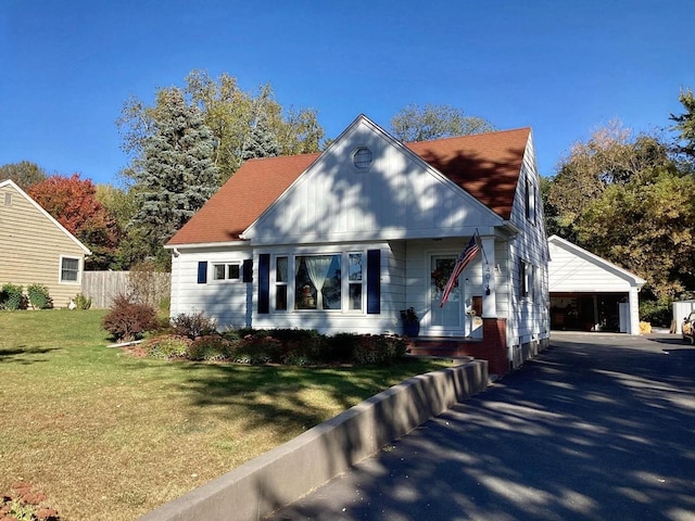 bungalow-style home with a carport and a front lawn