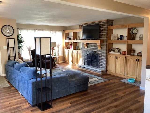 living room featuring dark hardwood / wood-style flooring and a brick fireplace