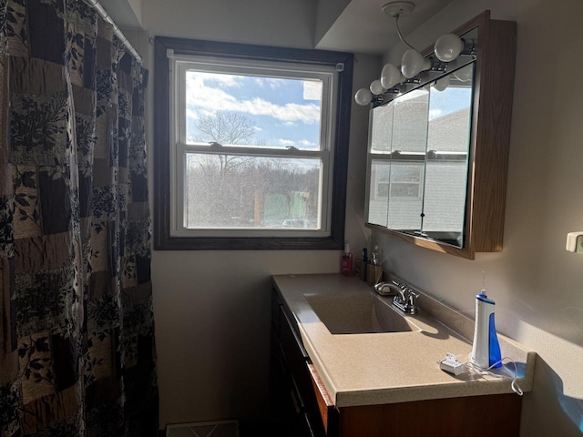 bathroom featuring a shower with shower curtain and vanity