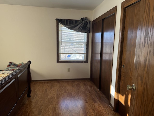 bedroom with dark hardwood / wood-style floors