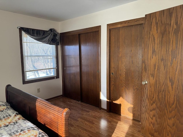 bedroom with dark wood-type flooring