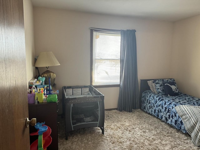 bedroom featuring multiple windows and carpet floors