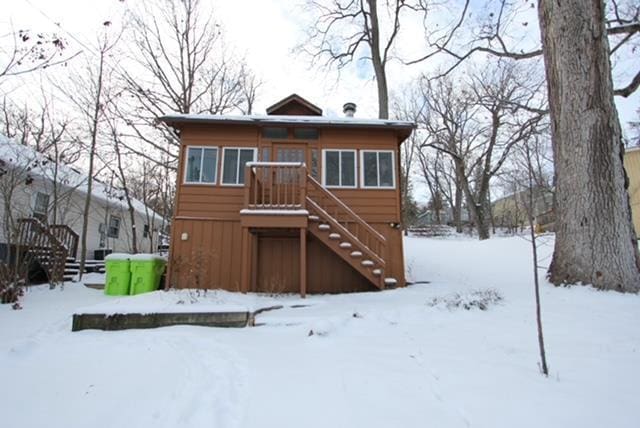 snow covered house with stairway