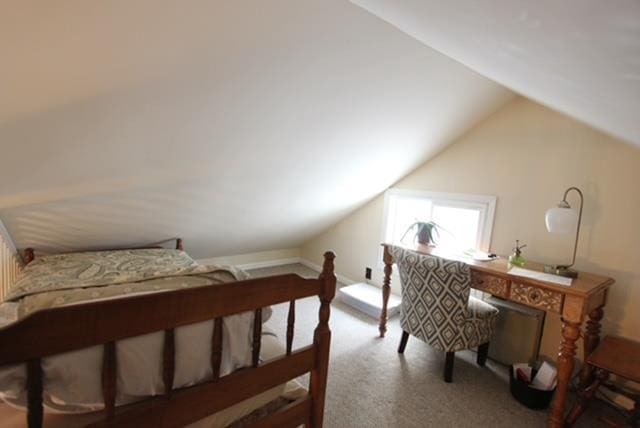 bedroom with carpet and lofted ceiling