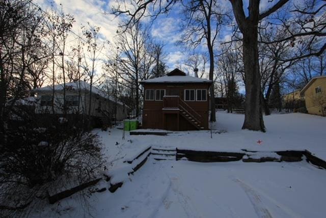 view of snow covered back of property