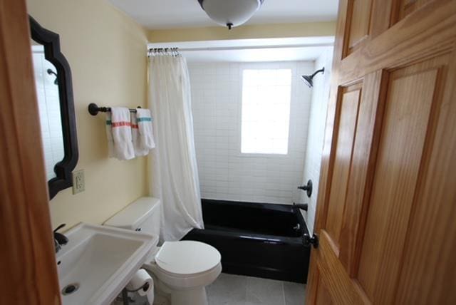 full bathroom with toilet, sink, shower / bath combination with curtain, and tile patterned flooring