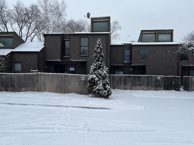 view of snow covered rear of property