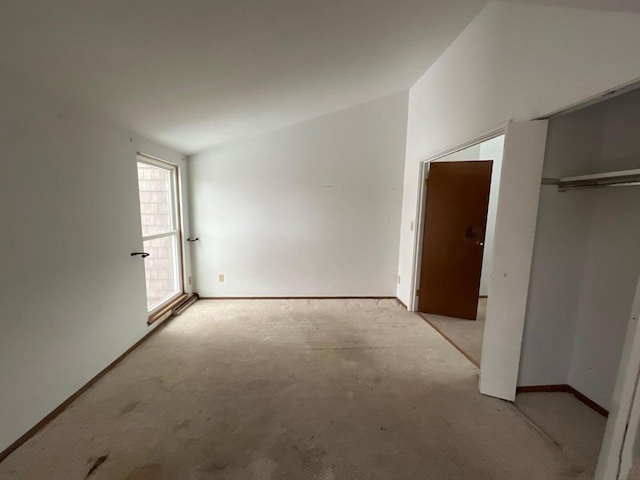 unfurnished bedroom featuring light carpet and a closet